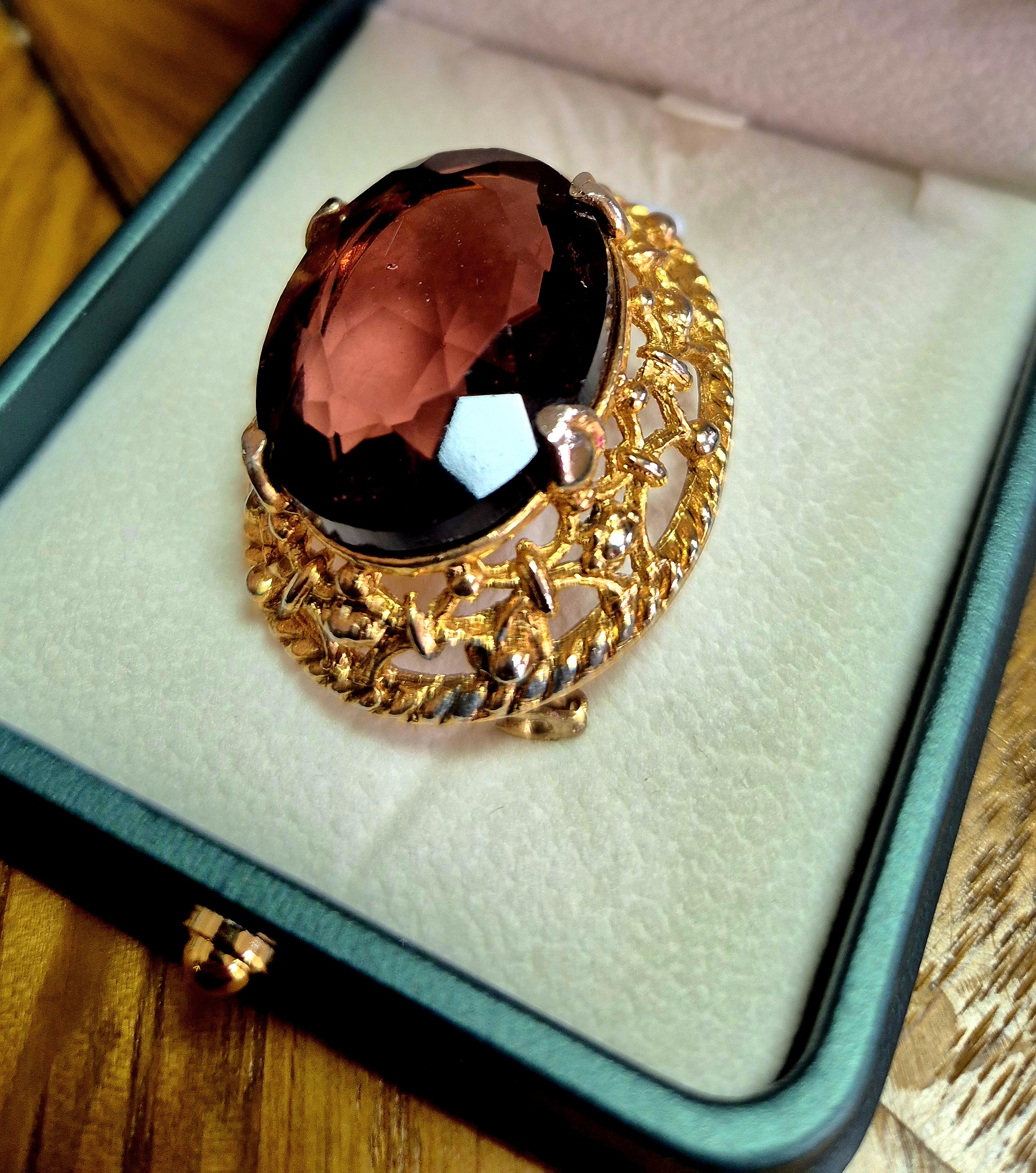Early 1900's with gold colour mount and stone, possibly Garn